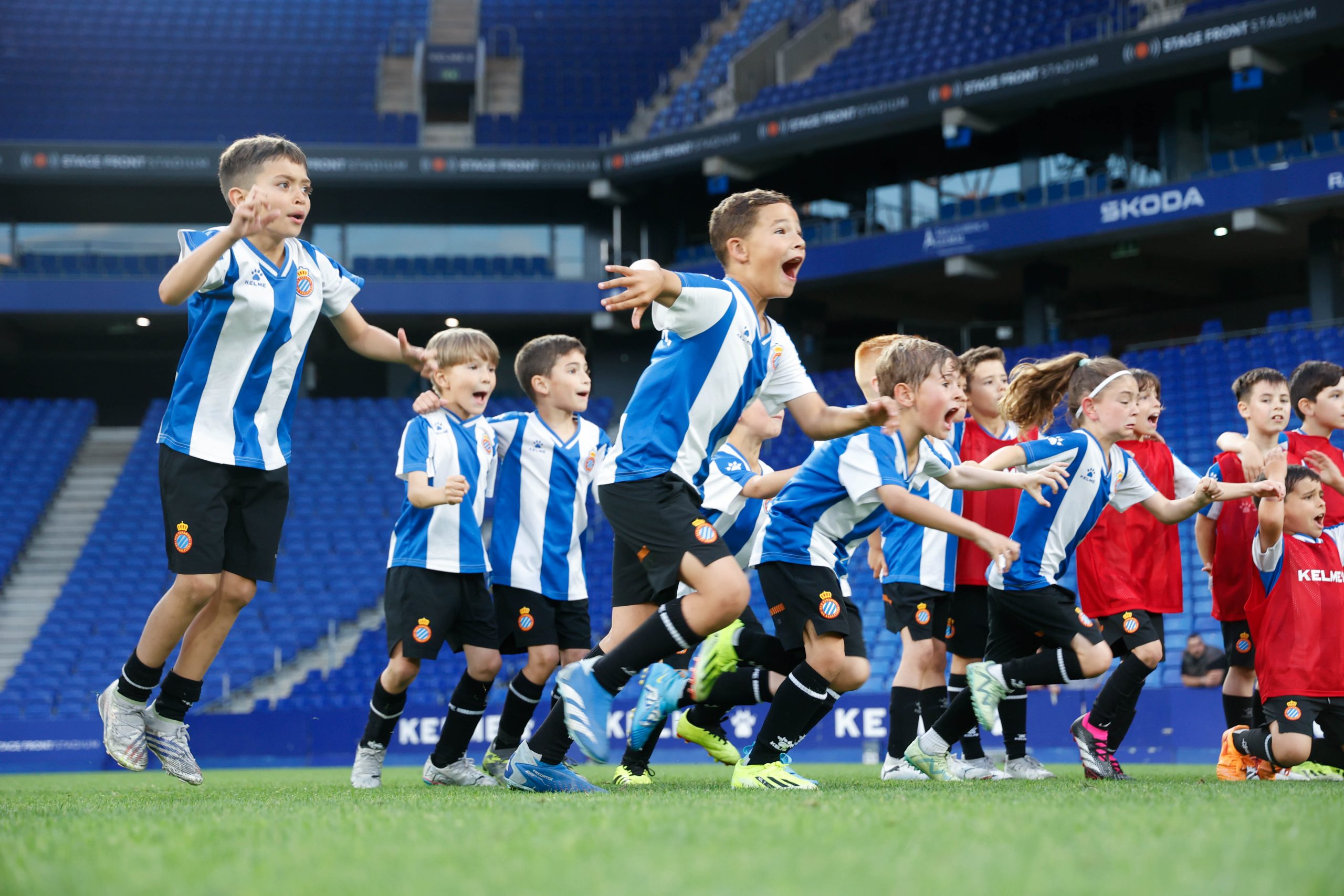 Two young academy players battling for the ball at the RCDE Stadium